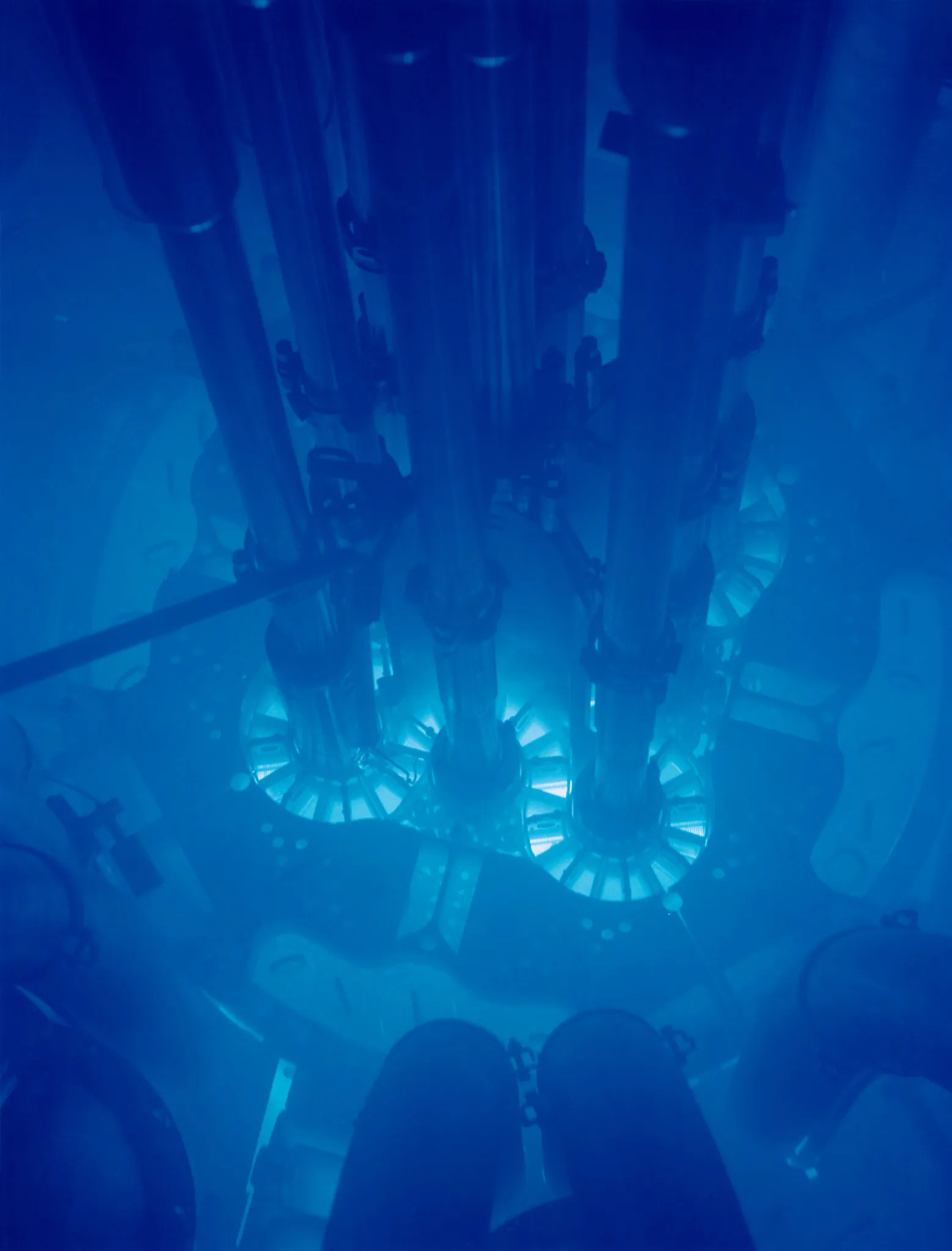 The core of the Advanced Test Reactor at Idaho National Laboratory, glowing blue from Cherenkov light given off by charged particles moving through the water that cools and shields it.