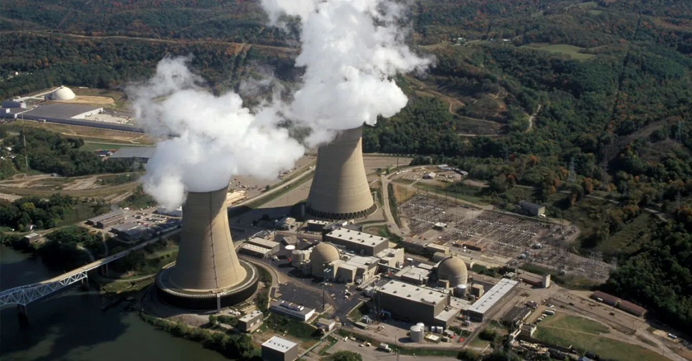 Aerial view of Beaver Valley Power Station on the Ohio River in Shippingport, Pennsylvania, with water vapor rising from both cooling towers.